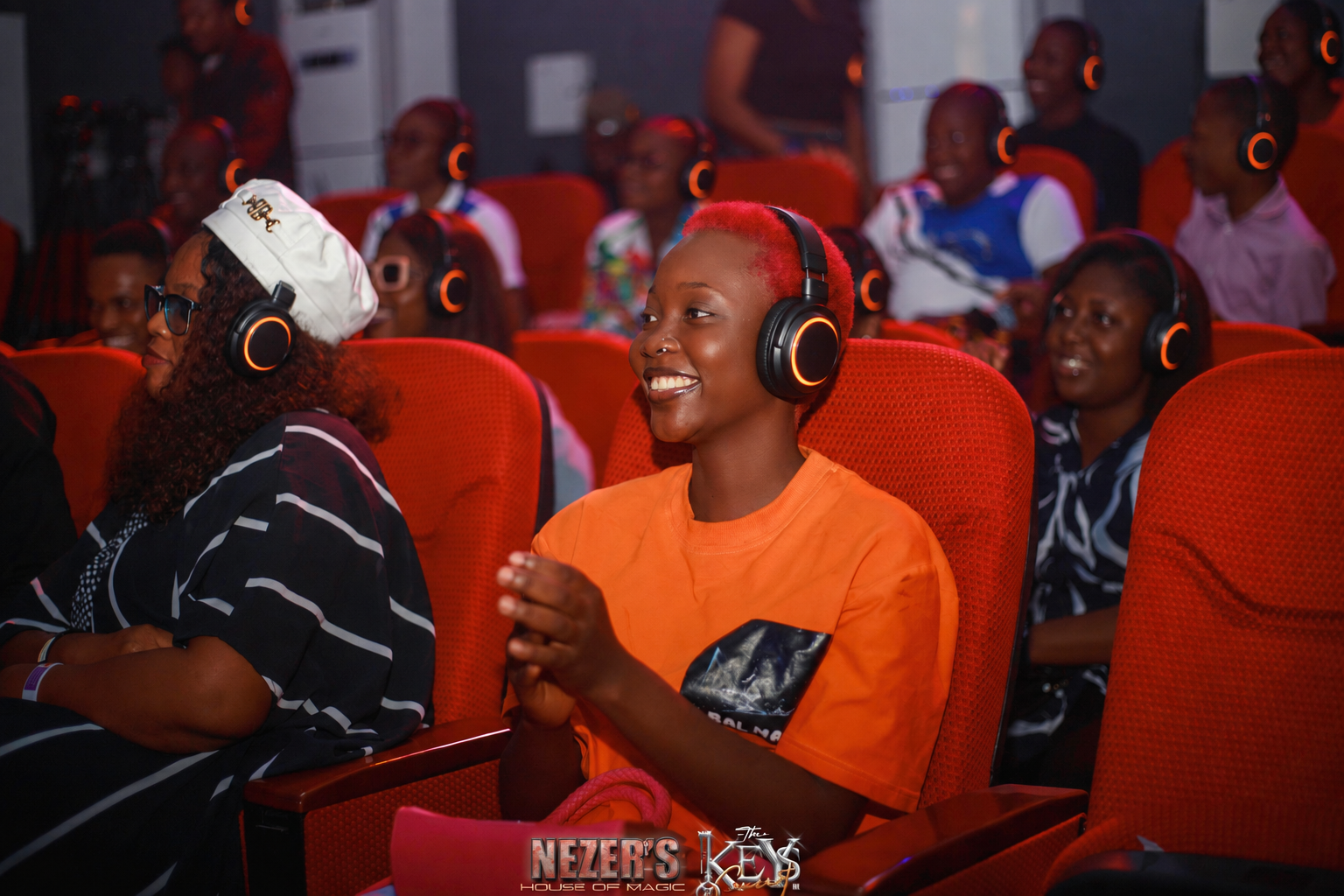 Campaign visualisation of an audience listening through orange-lit headsets
